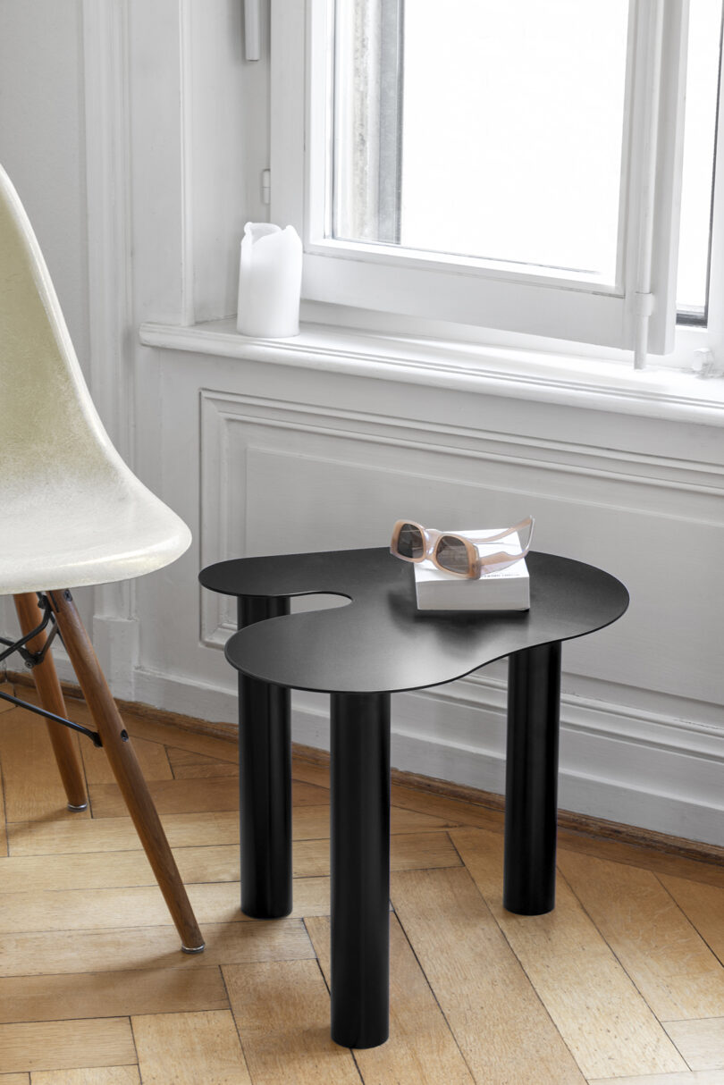 black occasional table in a styled living space