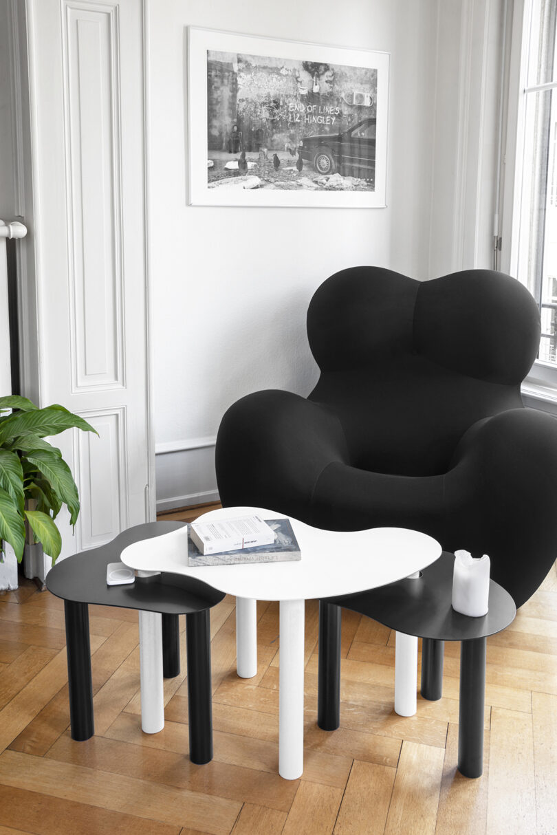 three black and white abstract shaped nested tables in a styled living space