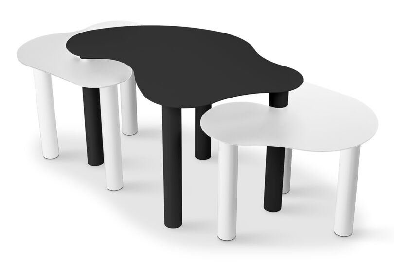 three black and white abstract shaped nested tables on a white background