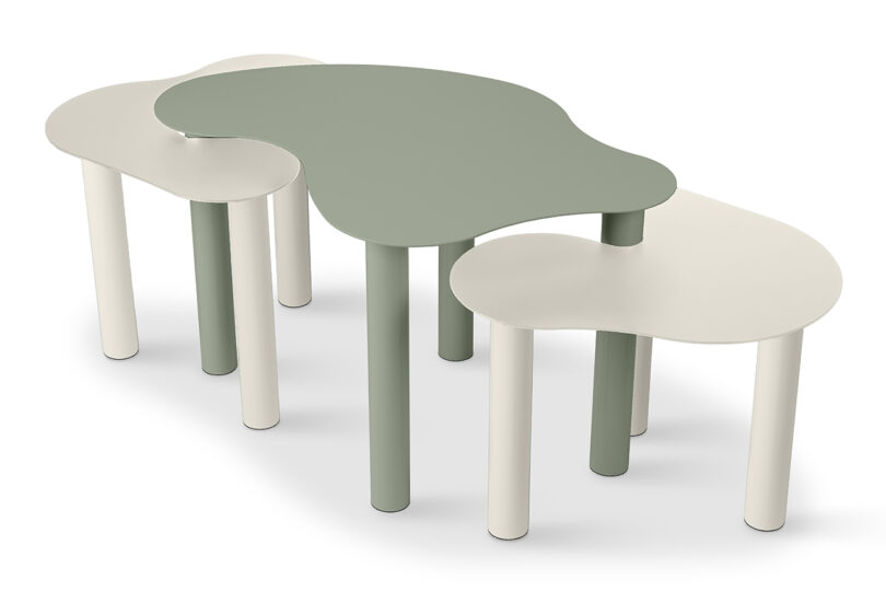 three sage green and cream abstract shaped nested tables on a white background