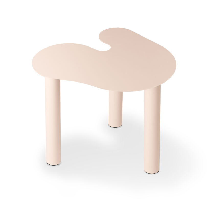 pink abstract shaped occasional table on a white background