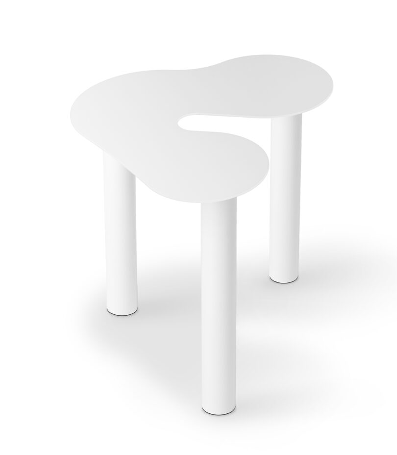 white abstract shaped occasional table on a white background