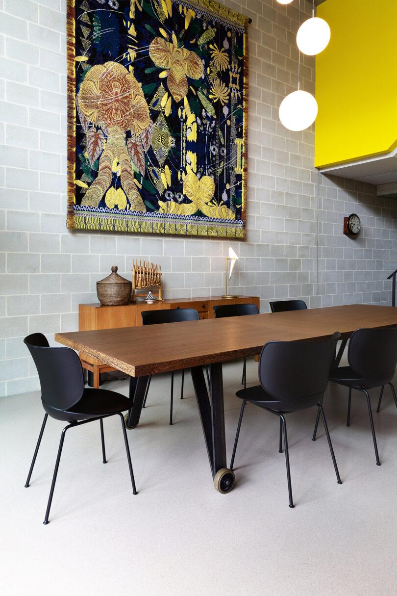 modern black chairs around a long wood table