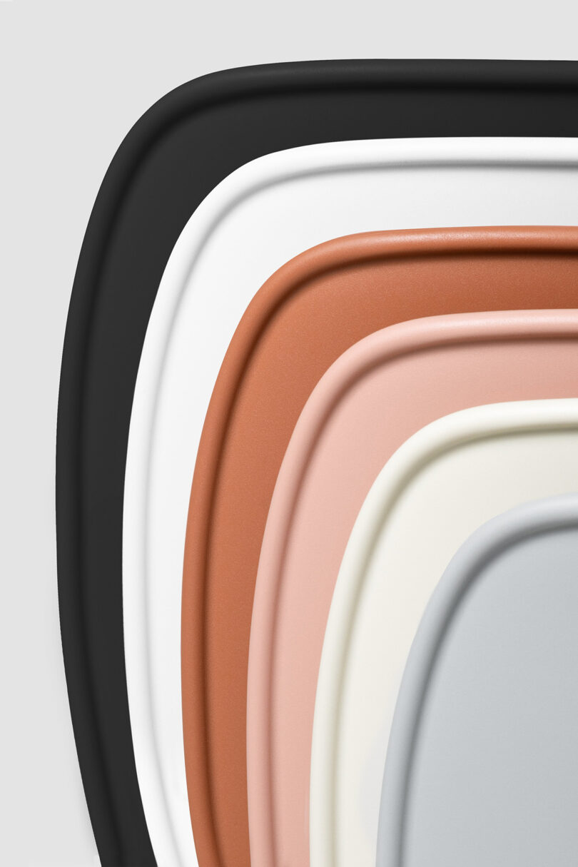 detail of stacked modern chairs in various colors on a white background