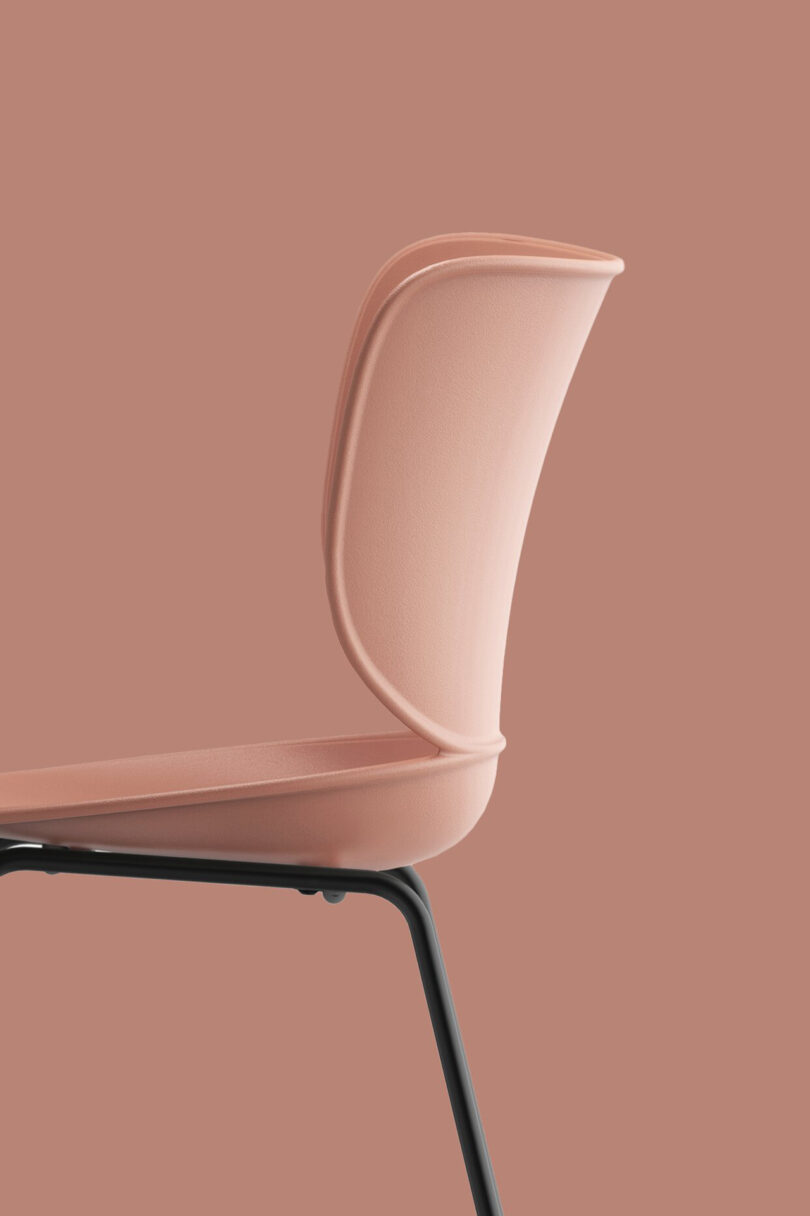 detail of modern pink chair on pink background