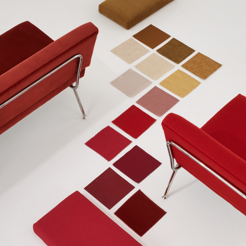 two red lounge chairs intersected by a path of color swatches