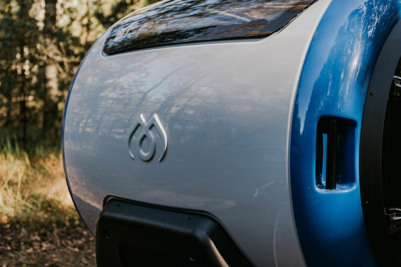 closeup of front part of gray and blue teardrop camper