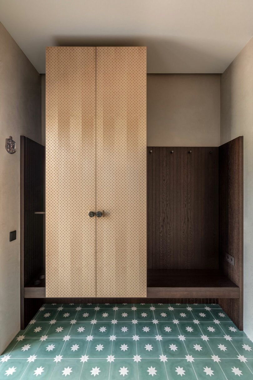 modern foyer with large wood cabinet and green and white tile patterned floor