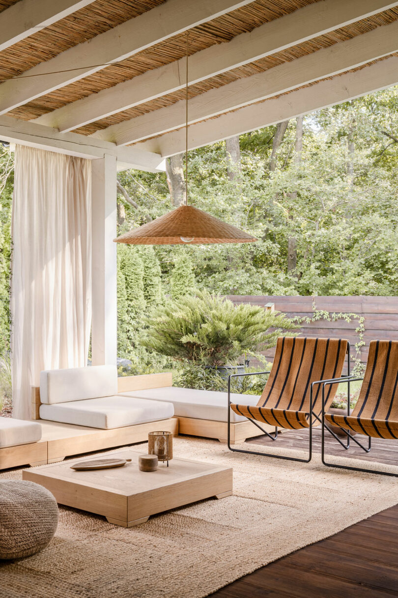 angled view under covered patio of modern house with modern outdoor seating