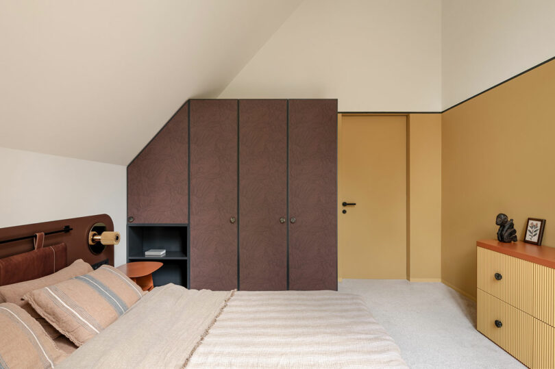 side view in modern bedroom with dark wood cabinets built in.
