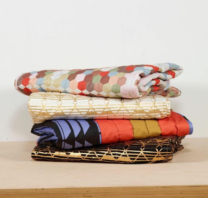 stack of textiles with maximalist patterns
