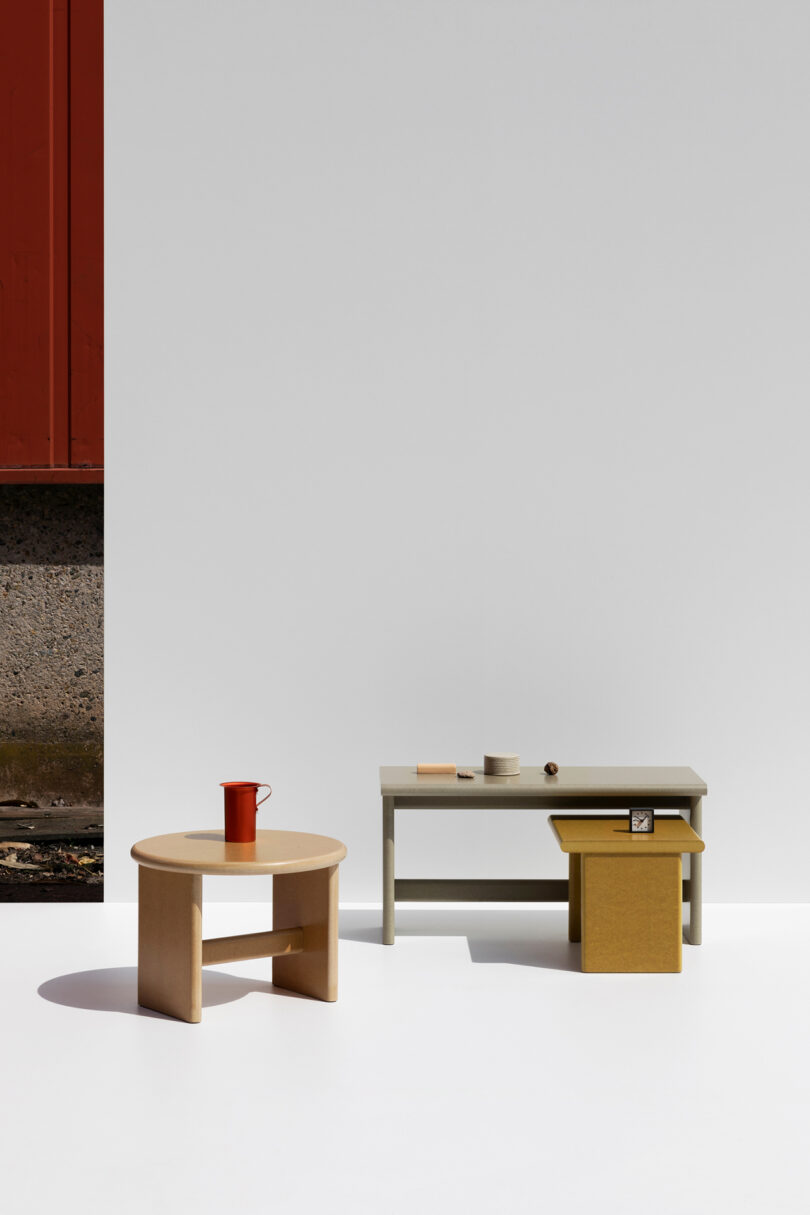 one rectangle-shaped table and two round tables in a studio setting
