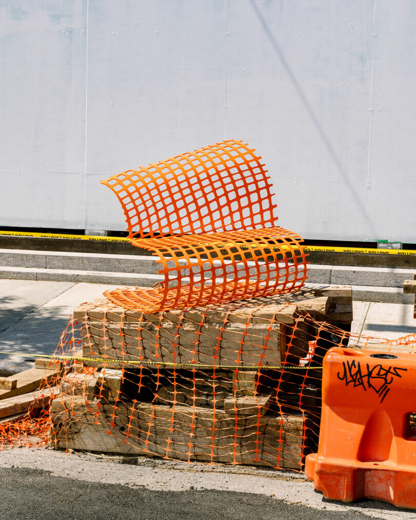 abstract chair made of bright orange snow fencing
