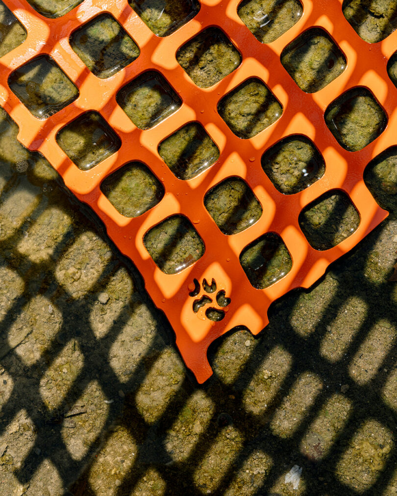 detail of abstract chair made of bright orange snow fencing