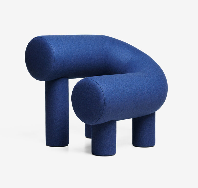 blue C-shaped armchair on white background