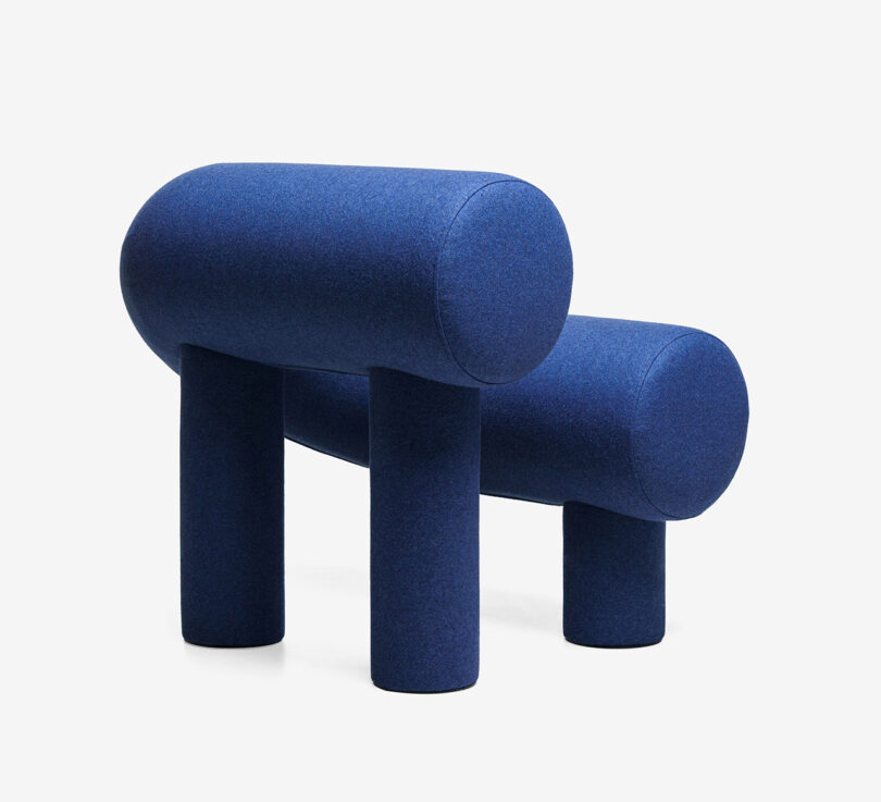 blue C-shaped armchair on white background