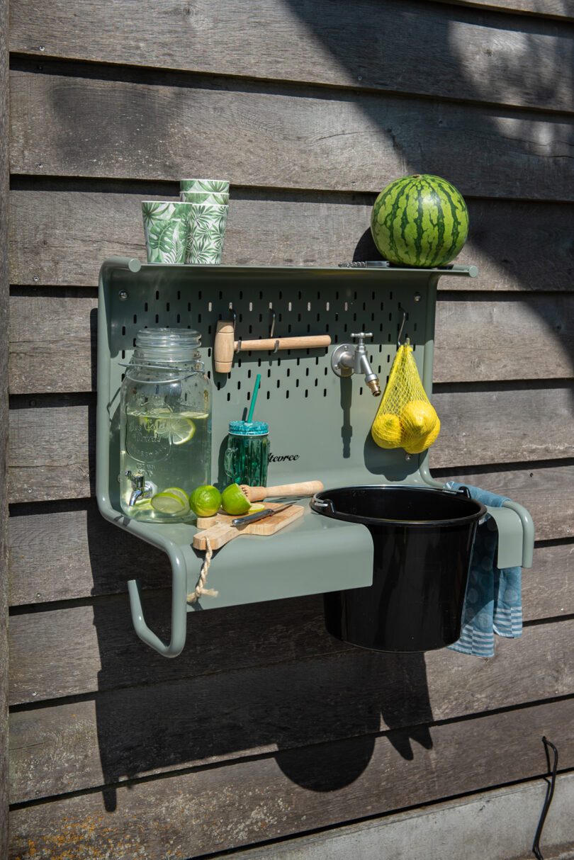 outdoor wall mounted shelf sink set up as a cocktail bar