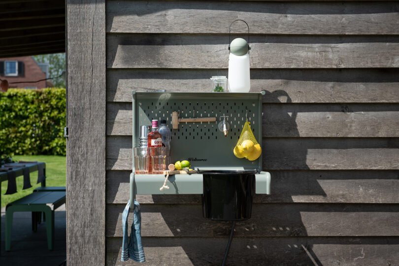 outdoor wall mounted shelf sink set up as a cocktail bar