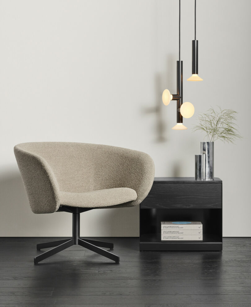 lounge chair next to pendant light collection and night stand