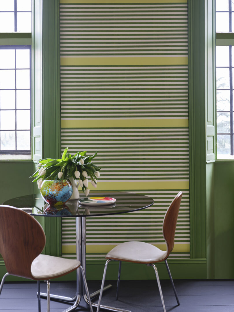 green stripe wallpaper with dining table and dining chairs