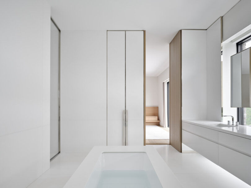 Spacious white marble bathroom with vanity