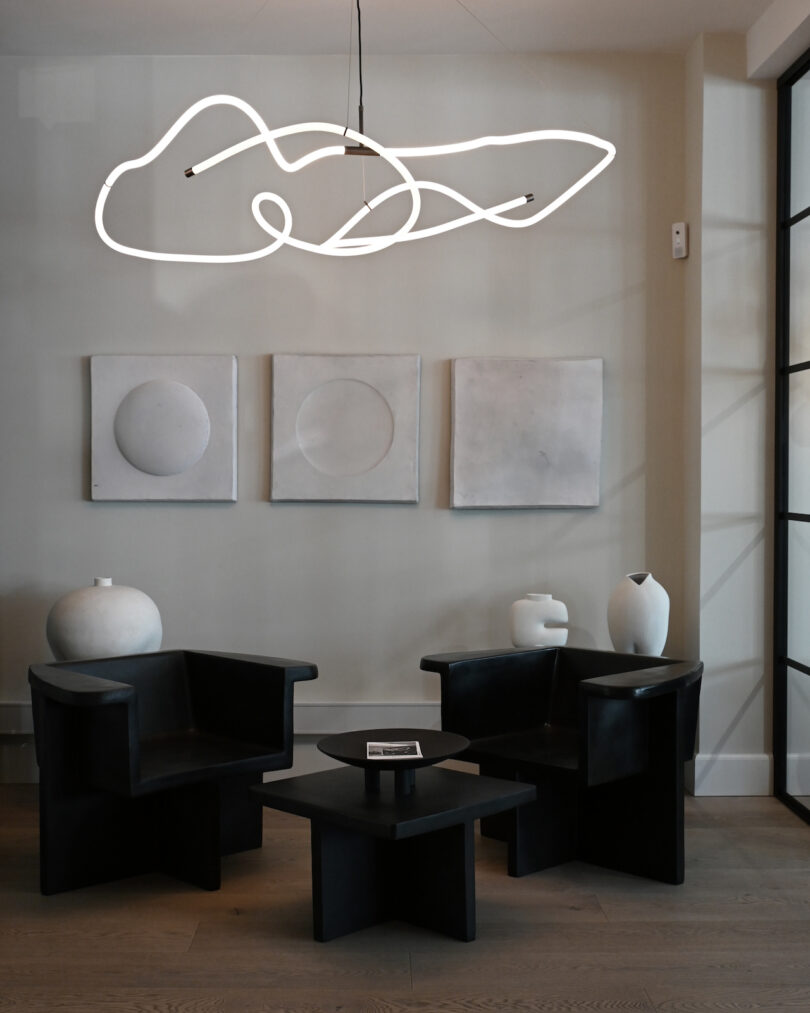 white pendant light in monochromatic living room