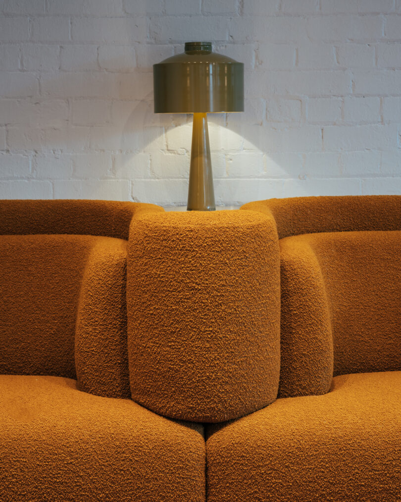 integrated brown seating next to metal lamp