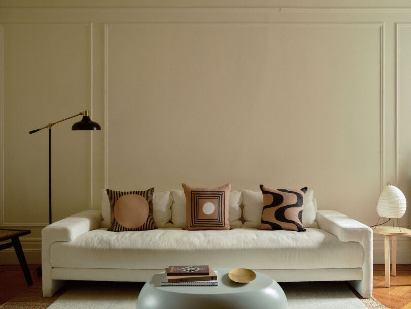 three pillows on a white day bed in living room