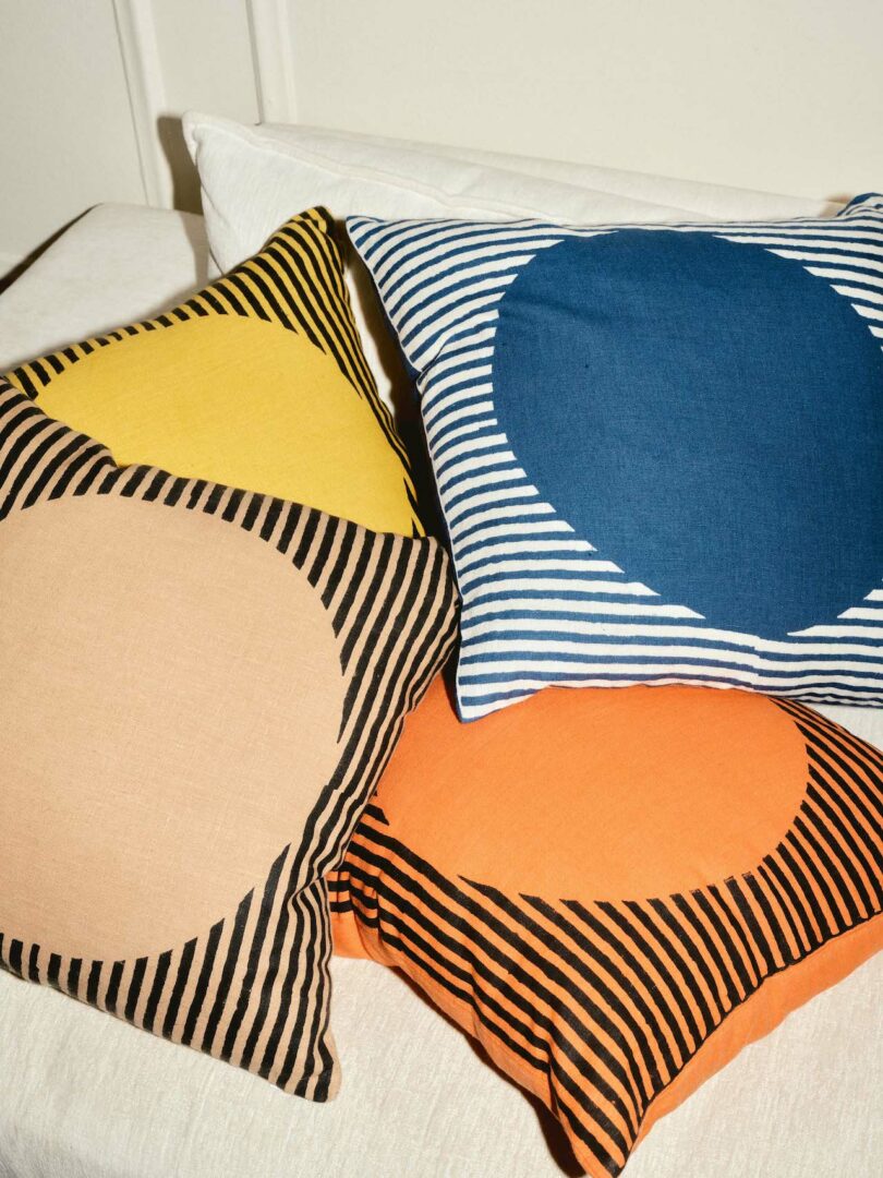 four circle pillows on white sofa