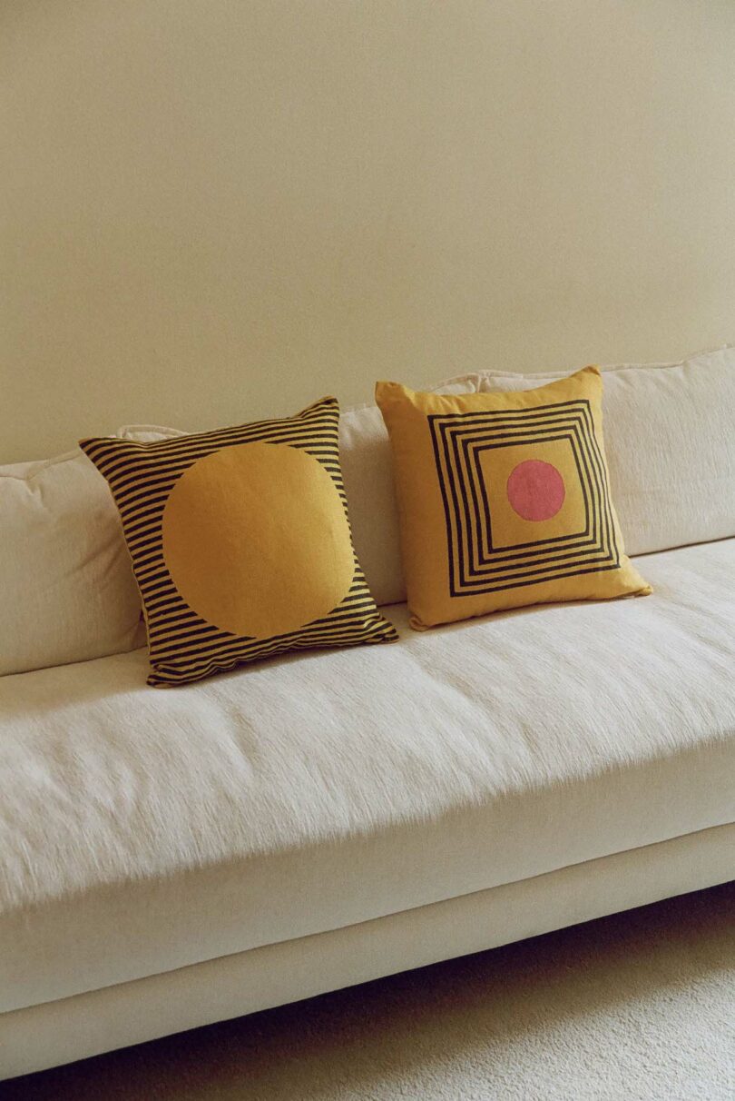 two pillows on white sofa