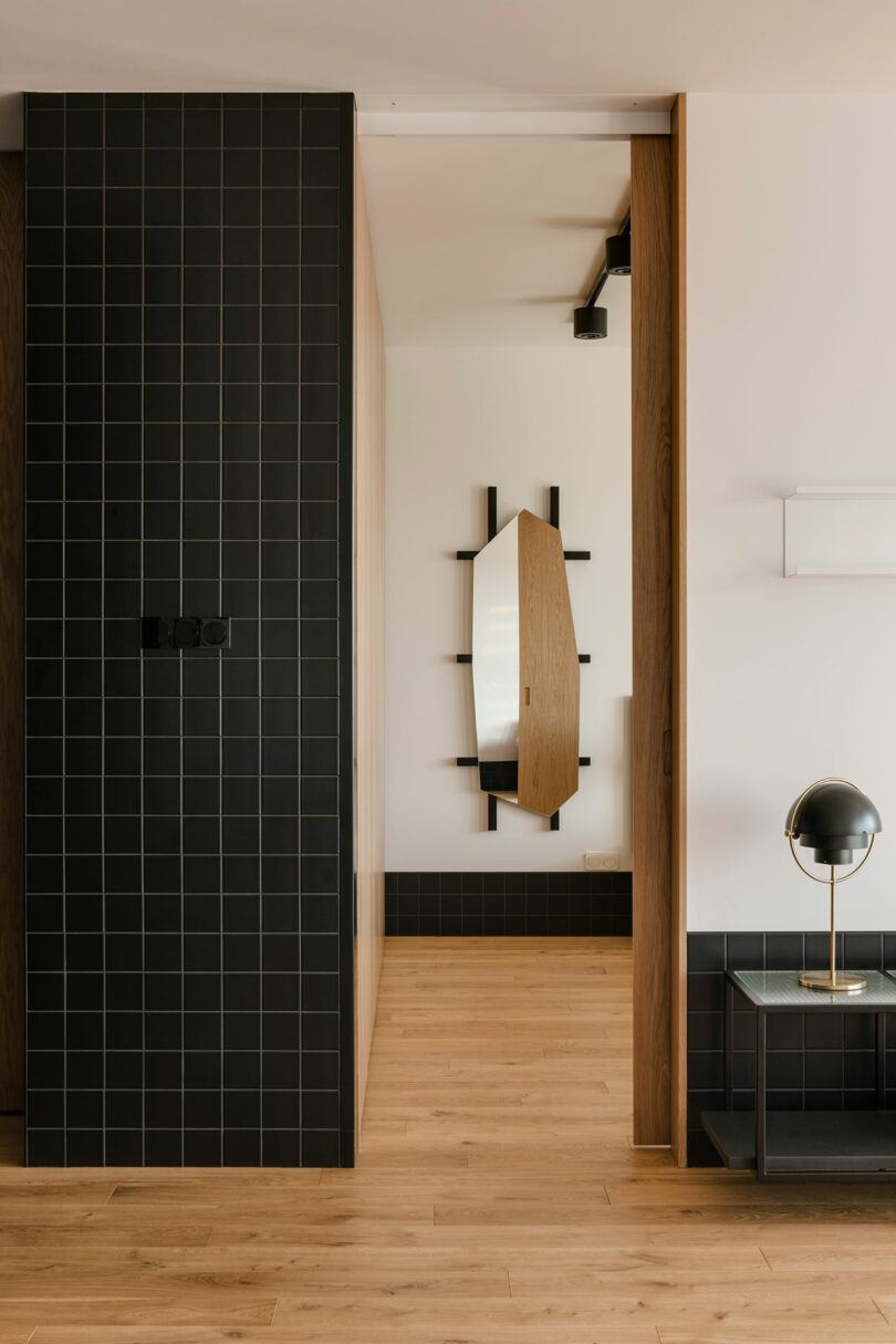 interior view into open door looking into bedroom with unique mirror on wall