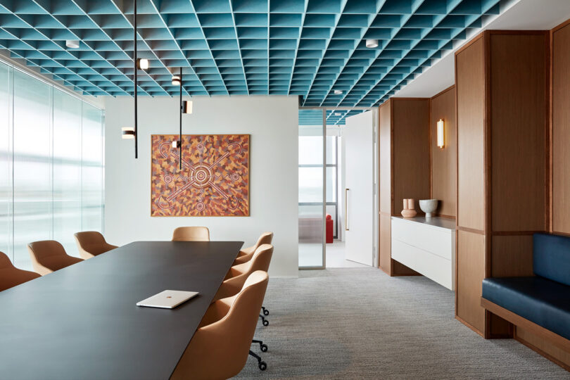 conference space with table and chairs and a teal ceiling