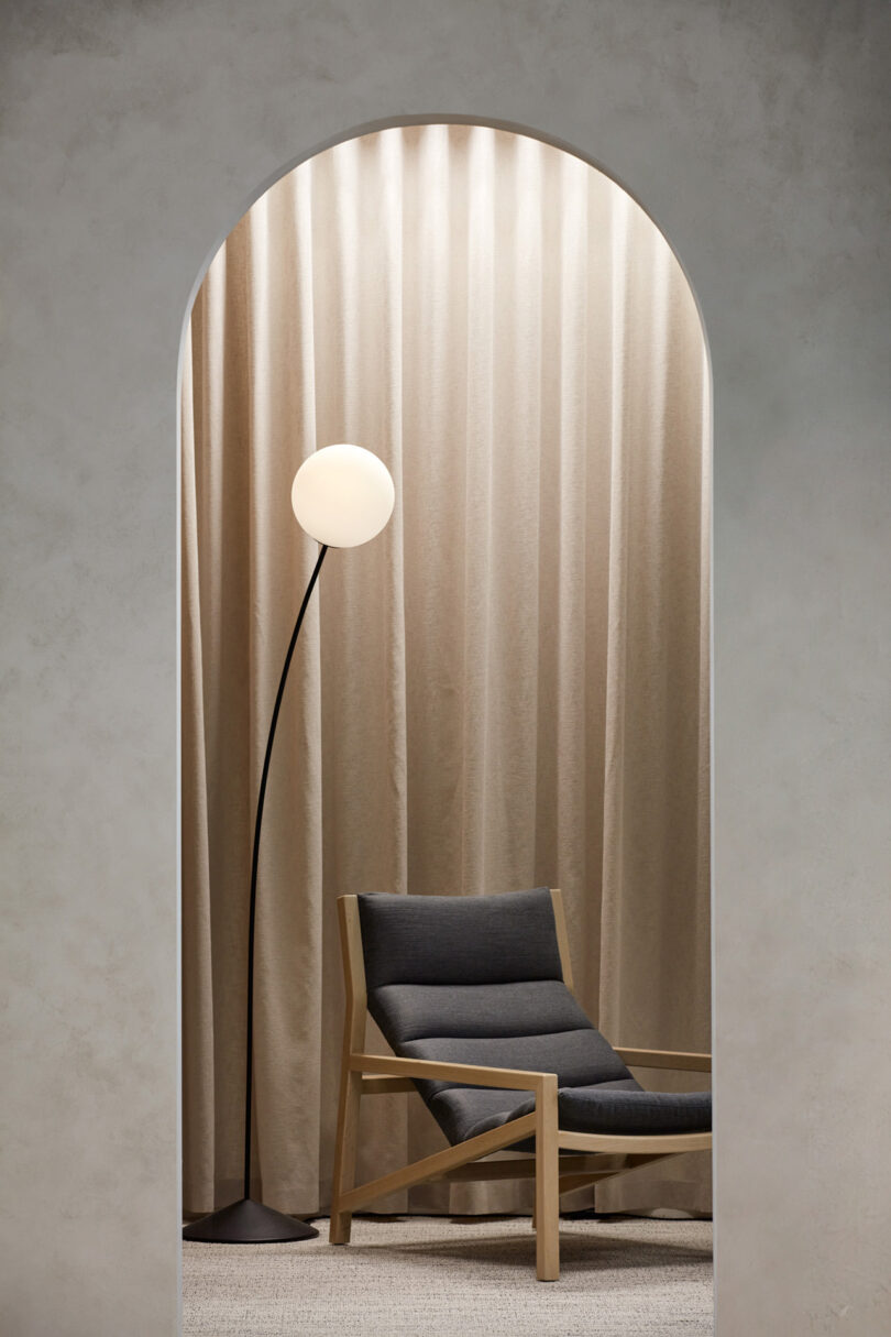 office enclave with armchair and floor lamp in neutral tones