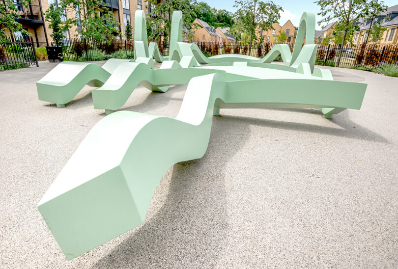 large seafoam green abstract undulating outdoor interactive art installation