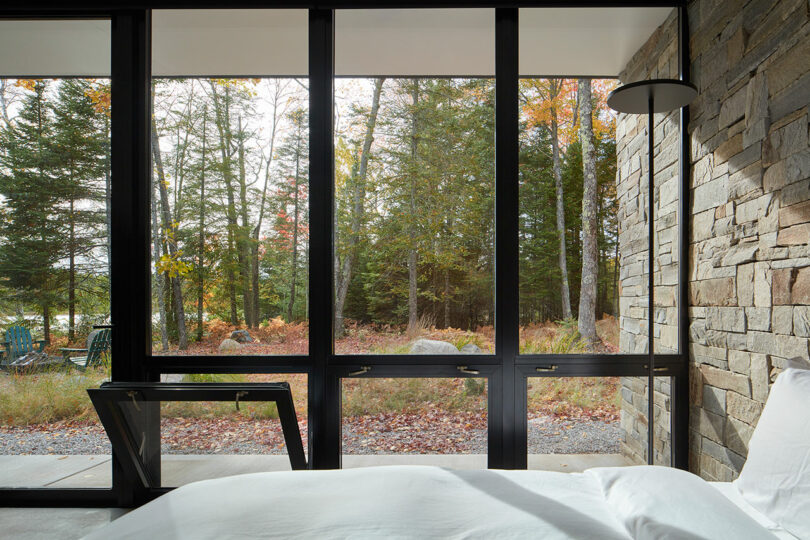 partial interior shot of modern bedroom with stone and glass walls