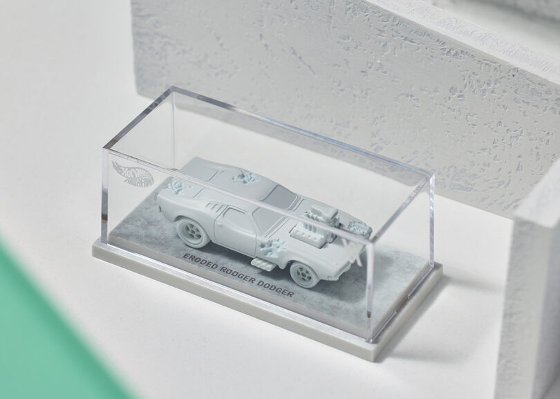 Daniel Arsham x Hot Wheels collection Dodge Charger vehicle model made from Silkstone encased in a clear display case, with the label "ERODED RODGER DODGERS" across the bottom.