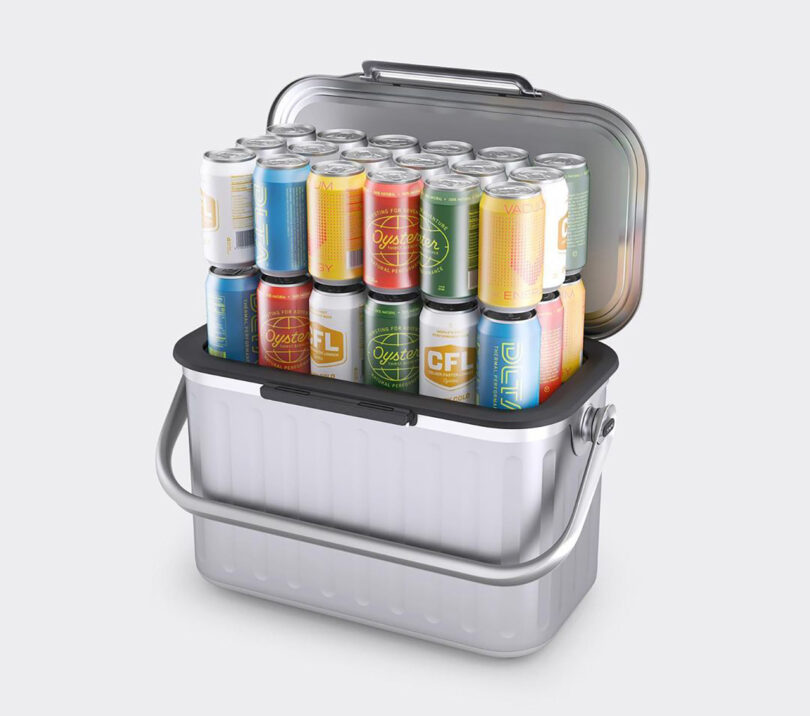 Aluminum cooler with handle with 36 colorful aluminum drink cans placed inside to illustrate the cooler's capacity