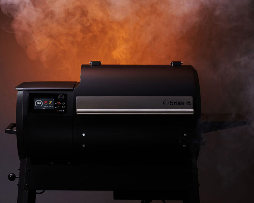 Black barbecue grill labeled Brisk It with smoke emanating from the top