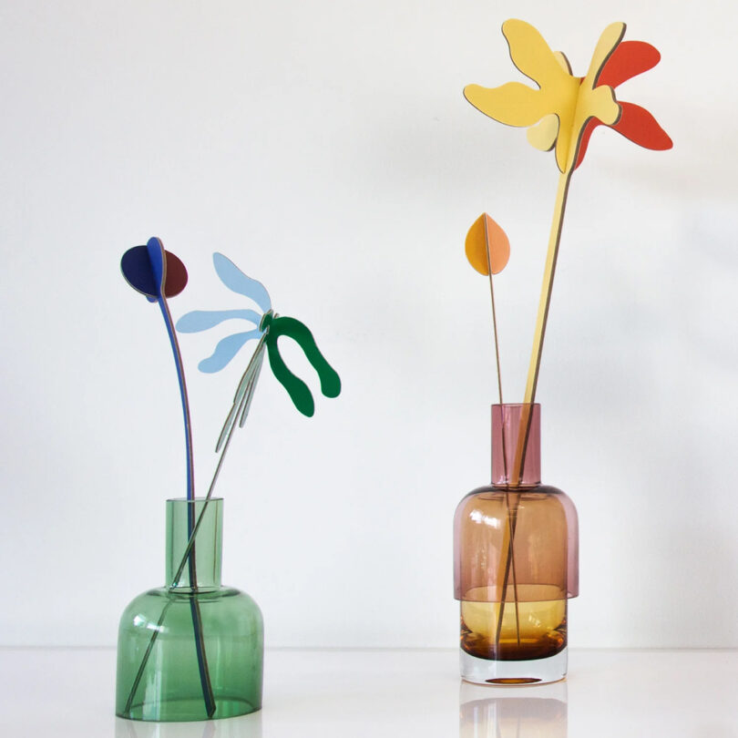 two colorful glass vases with flowers