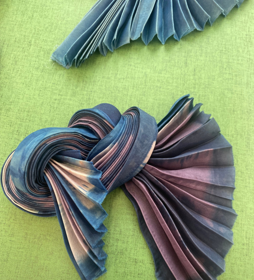 A pleated and knotted multi-coloured fabric.