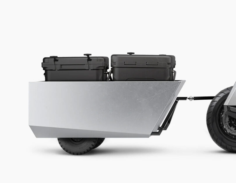 The P1 optional rear trailer system shown attached to a cropped rear section of the scooter with two black plastic storage units inside.