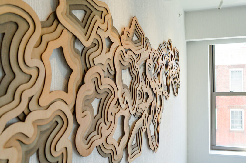 detail of abstract layered wooden wall sculpture