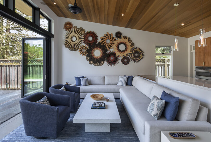 abstract layered wooden wall sculpture installed in a living room