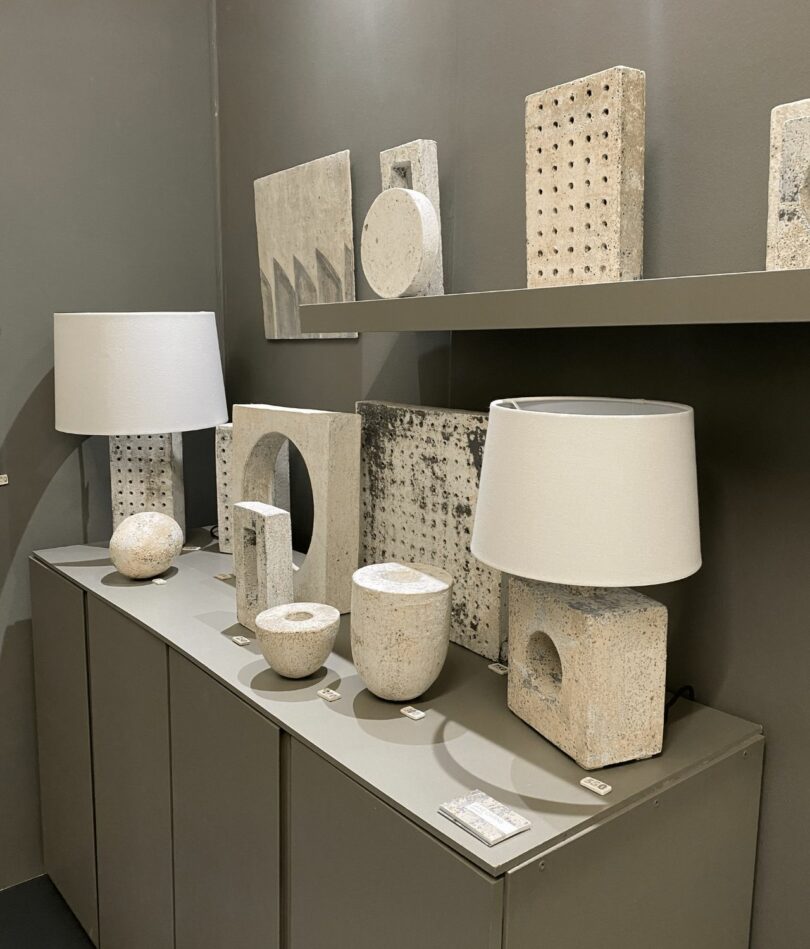 A series of square lamps, vessels and wall hangings in shades of white and cream – some feature circular perforations.