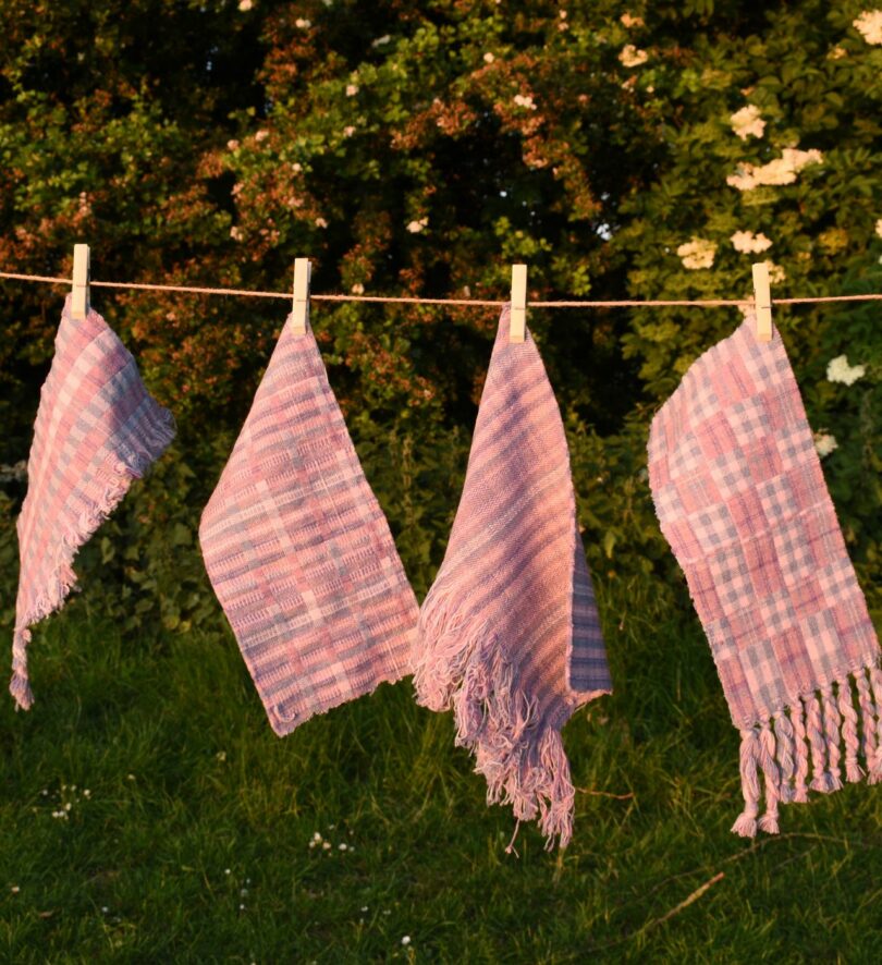 Woven samples hang on a washing line