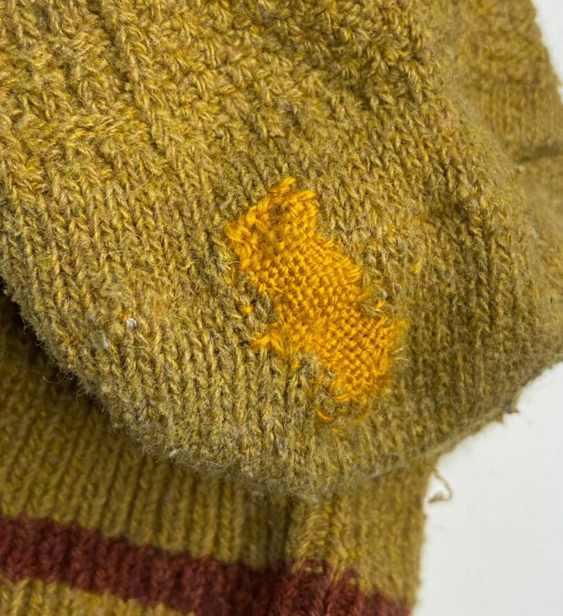 A green sock darned in yellow