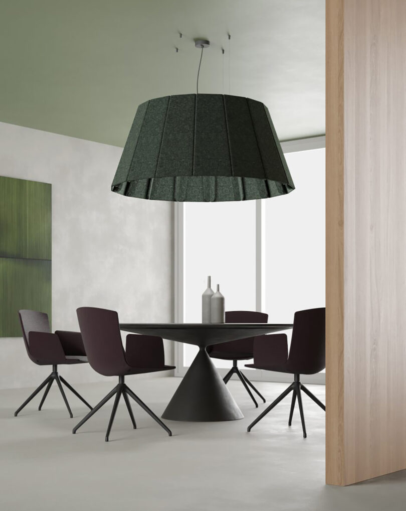 Large green textile 58.3" Vapor Echo pendant set above circular meeting room with wood panel walls and green tinged ceiling near frosted windows.