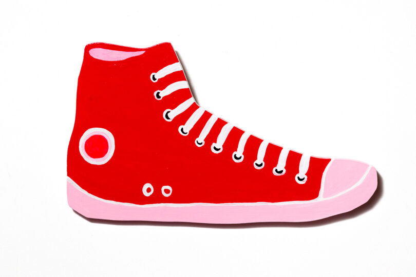 red and pink high-top shoe painted on woodred and pink high-top shoe painted on wood