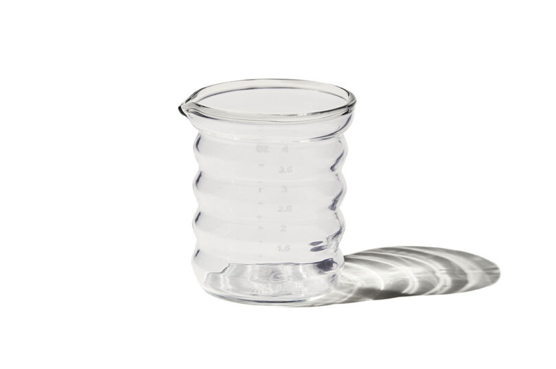 clear rippled glass jigger on white background