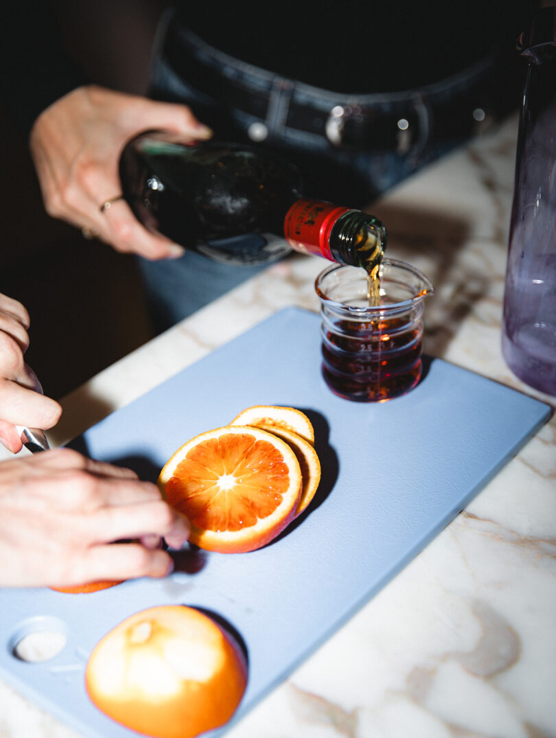high contrast flash image of someone pouring a cocktail